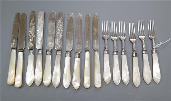 A set of six Edwardian silver dessert knives and forks with mother of pearl handles by Mappin & Webb and four ditto knives.